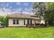 Spacious backyard featuring a large deck, green lawn, and mature trees, perfect for outdoor entertaining and relaxation at 3404 Pasture View Ct, Charlotte, NC 28269