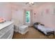Charming pink bedroom designed for a , featuring a toddler bed, a dresser, and a comfortable armchair at 3404 Pasture View Ct, Charlotte, NC 28269