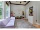 Bright bedroom featuring a plush purple sofa, large windows and plenty of space for play and learning at 3404 Pasture View Ct, Charlotte, NC 28269