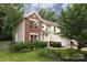 Charming two-story home with a brick and siding facade, a well-manicured front yard, and an attached two-car garage at 3404 Pasture View Ct, Charlotte, NC 28269