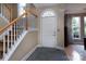 Inviting foyer with tile flooring, staircase, and front door with decorative window at 3404 Pasture View Ct, Charlotte, NC 28269