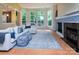 Bright living area featuring a fireplace, large windows, and a comfortable sectional sofa with stylish accents at 3404 Pasture View Ct, Charlotte, NC 28269
