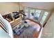 Bright, open living room featuring hardwood floors, large windows, and a comfortable sectional sofa at 3404 Pasture View Ct, Charlotte, NC 28269