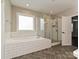 Bright bathroom featuring a soaking tub and a glass enclosed shower at 358 Hampton Trail Dr, Fort Mill, SC 29708