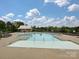 Community pool with a large deck area, lounge chairs, and a pool house under a sunny sky at 358 Hampton Trail Dr, Fort Mill, SC 29708