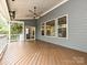 Spacious covered deck featuring stained wood flooring, outdoor speakers, and a view of the backyard at 358 Hampton Trail Dr, Fort Mill, SC 29708