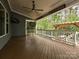 Covered deck with ceiling fan, outdoor heater, stained wood flooring, and view of the wooded backyard at 358 Hampton Trail Dr, Fort Mill, SC 29708