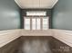 Elegant dining room featuring wainscoting, hardwood floors, and stylish chandelier at 358 Hampton Trail Dr, Fort Mill, SC 29708