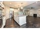 Open-concept kitchen featuring quartz counters, stainless appliances, and transitions into living area at 358 Hampton Trail Dr, Fort Mill, SC 29708