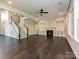 Living room featuring fireplace, built-in shelves, large windows, and an open staircase at 358 Hampton Trail Dr, Fort Mill, SC 29708