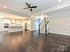 Open-concept living space with hardwood floors, and access to the kitchen and staircase at 358 Hampton Trail Dr, Fort Mill, SC 29708