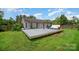 Backyard featuring a spacious wooden deck and green lawn, ideal for outdoor activities at 3606 White Swan Ct, Indian Trail, NC 28079