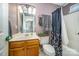 Functional bathroom with a combined shower and tub, toilet, and vanity with storage at 3606 White Swan Ct, Indian Trail, NC 28079