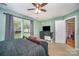 Another view of the cozy bedroom featuring carpet flooring, and a large window at 3606 White Swan Ct, Indian Trail, NC 28079