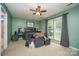 Comfortable bedroom with ceiling fan, carpet flooring, and a large window for natural light at 3606 White Swan Ct, Indian Trail, NC 28079