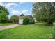 This is a charming home with a well-maintained lawn, a driveway, and an attached garage on a sunny day at 3606 White Swan Ct, Indian Trail, NC 28079
