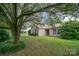 The house boasts a well-maintained lawn, and blue shutters enhancing the curb appeal, nestled under a large tree canopy at 3606 White Swan Ct, Indian Trail, NC 28079