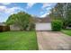 Attached two-car garage with a well-maintained lawn and a neatly paved driveway on a bright, sunny day at 3606 White Swan Ct, Indian Trail, NC 28079