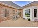 Back deck area featuring a wooden patio, brick walls, hanging lights, and outdoor seating at 3871 Cool Branch Dr, Maiden, NC 28650