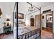 Bedroom featuring a four-poster bed, wood floors, a dark wood armoire, and neutral walls at 3871 Cool Branch Dr, Maiden, NC 28650