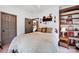 Cozy bedroom with neutral walls, a bed with a decorative blanket, and a wooden bookshelf at 3871 Cool Branch Dr, Maiden, NC 28650