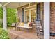 Cozy porch swing on a brick porch with classic brick architecture at 3871 Cool Branch Dr, Maiden, NC 28650