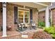 Charming front porch features a brick floor with rocking chairs and tasteful decor at 3871 Cool Branch Dr, Maiden, NC 28650