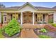 Charming covered porch featuring a brick floor, wood columns, and comfortable seating at 3871 Cool Branch Dr, Maiden, NC 28650