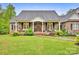 Inviting brick home with a charming front porch and meticulously landscaped garden at 3871 Cool Branch Dr, Maiden, NC 28650
