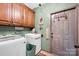 Functional laundry room with ample cabinet storage, a washer and dryer, and a utility sink at 3871 Cool Branch Dr, Maiden, NC 28650