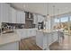 Modern kitchen featuring white cabinets, an island with pendant lighting and stainless steel appliances at 4100 Alexander View Dr # 1, Charlotte, NC 28226