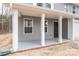 Welcoming front porch with white columns and gray siding detail at 4149 River Run Cir, Hickory, NC 28602