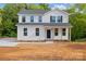 Charming two-story home featuring a welcoming front porch and freshly landscaped yard on a sunny day at 4175 River Run Cir, Hickory, NC 28602