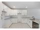 Modern kitchen featuring pristine white cabinets, light countertops, and luxury vinyl plank flooring at 4175 River Run Cir, Hickory, NC 28602