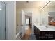 Bathroom with dual sink vanity, a bathtub, and view into bedroom at 4315 Barnside Ln, Charlotte, NC 28216