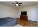 Bedroom with ceiling fan, dresser, and two doorways at 4315 Barnside Ln, Charlotte, NC 28216
