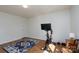 A simple bedroom featuring hardwood floors, neutral walls, and space for exercise equipment at 4315 Barnside Ln, Charlotte, NC 28216