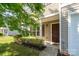 Inviting front entrance with a covered porch, lush landscaping, and a visible security system for added peace of mind at 4315 Barnside Ln, Charlotte, NC 28216