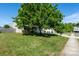 Home featuring a green lawn, large tree and private driveway at 4315 Barnside Ln, Charlotte, NC 28216