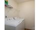 Functional laundry area with washer, dryer, and wire shelving for storage at 4315 Barnside Ln, Charlotte, NC 28216