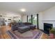 Open-plan living space featuring laminate flooring, a fireplace, and an eat-in kitchen in the background at 4315 Barnside Ln, Charlotte, NC 28216