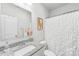 Bright bathroom with a granite countertop vanity and shower with white curtain at 476 Dudley Dr, Fort Mill, SC 29715
