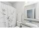 A well-lit bathroom with a floral shower curtain and a granite sink at 476 Dudley Dr, Fort Mill, SC 29715