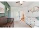 Cozy Bedroom featuring a dark wood crib and a charming decorative wall at 476 Dudley Dr, Fort Mill, SC 29715