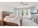 Inviting bedroom featuring large windows, wood furniture, and a ceiling fan at 476 Dudley Dr, Fort Mill, SC 29715