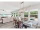 The dining area features a modern chandelier, hardwood floors, and backyard views at 476 Dudley Dr, Fort Mill, SC 29715