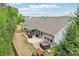 An elevated view shows a home with a stone patio, covered seating area, and hot tub at 476 Dudley Dr, Fort Mill, SC 29715