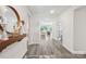 Bright entryway with hardwood floors and decorative mirror offers a welcoming feel at 476 Dudley Dr, Fort Mill, SC 29715