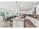 Modern kitchen with a large island, stainless appliances, and an adjacent dining area filled with light at 476 Dudley Dr, Fort Mill, SC 29715