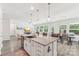 Bright, open kitchen with granite countertops, a farm sink, and an adjacent dining area at 476 Dudley Dr, Fort Mill, SC 29715